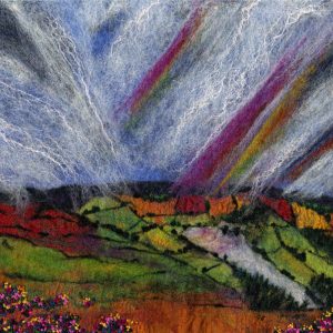 A Yorkshire landscape with autumn colours and rainbows in the sky Masham North Yorkshire. A felt landscape by Janine Jacques