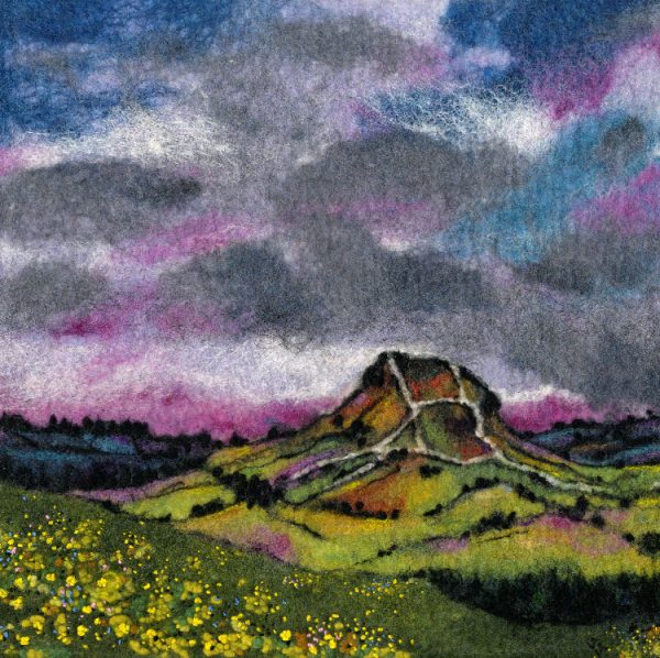 North Yorkshire Painting. A scenic view of Roseberry Topping from Captain Cooks Mounument car park. Roseberry Topping with buttercups growing in a field in the foreground. An original felt landscape by artist Janine Jacques